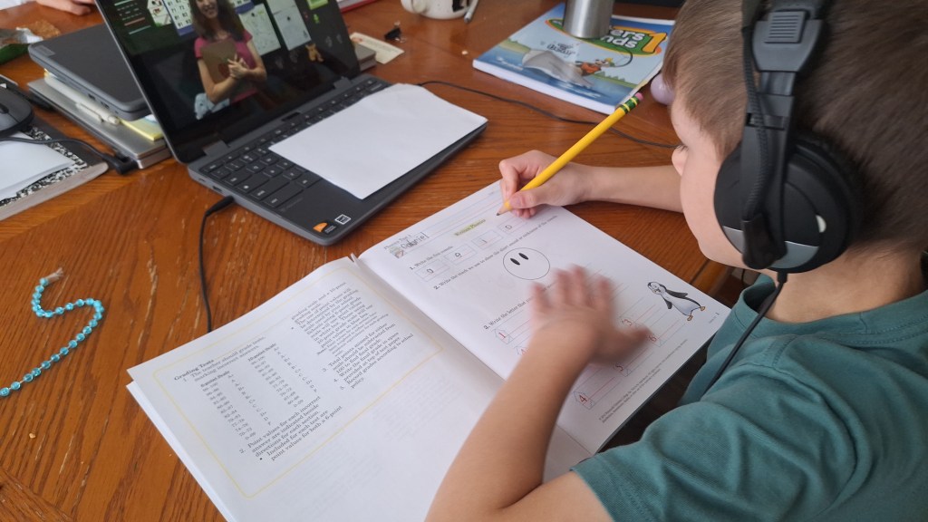 boy using Abeka Academy language arts video lessons for homeschooling