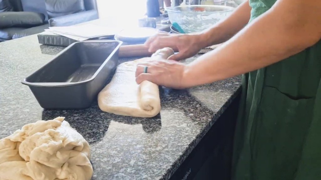 rolling bread dough to put in bread pan